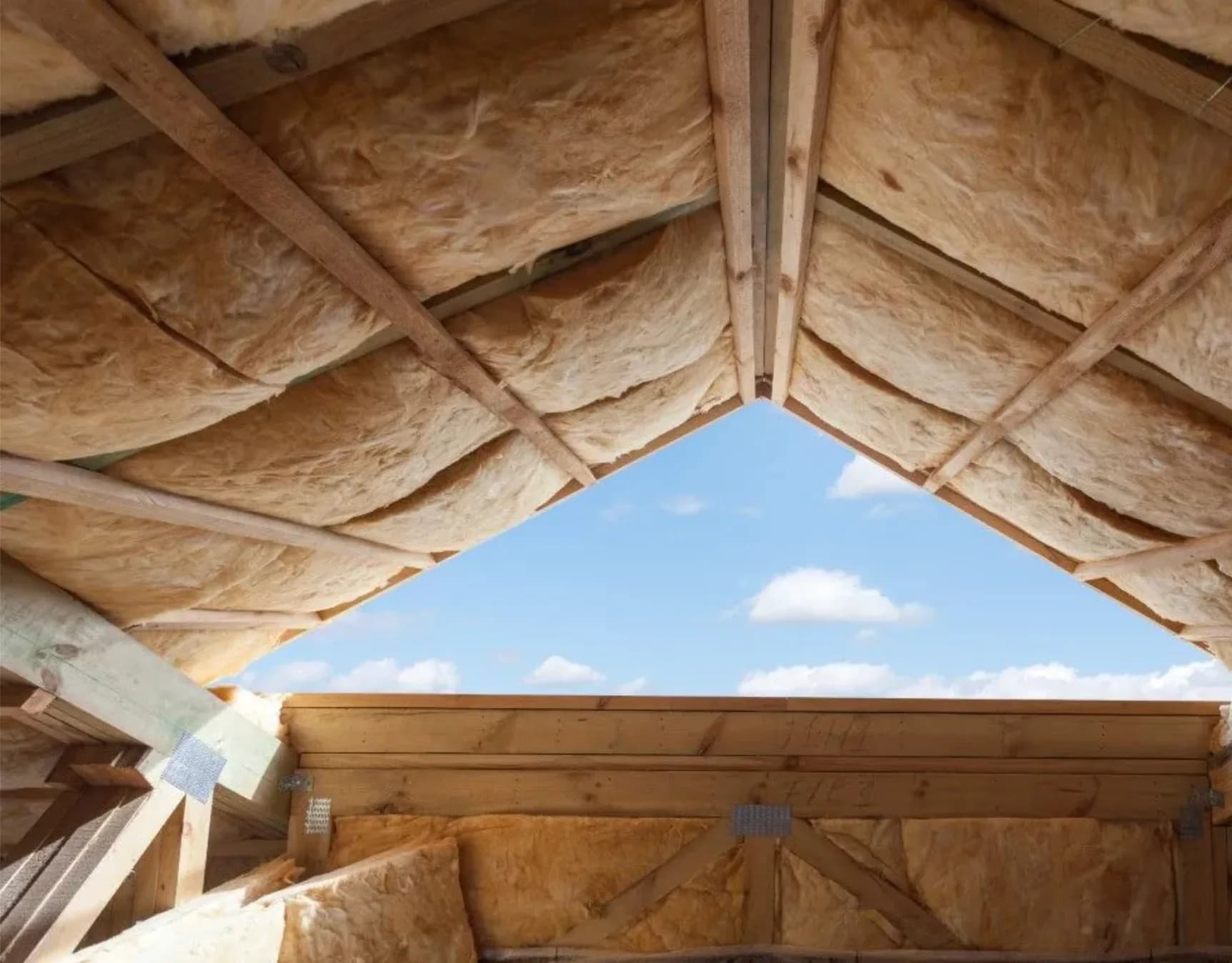 Roofline insulation installed between rafters under open sky