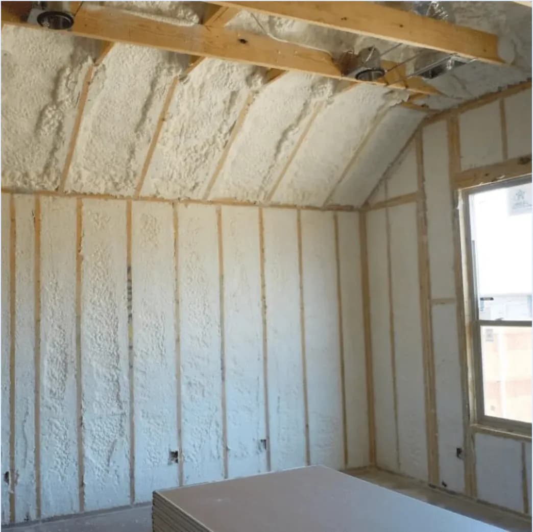 Spray foam insulation installed between wall studs and roof framing
