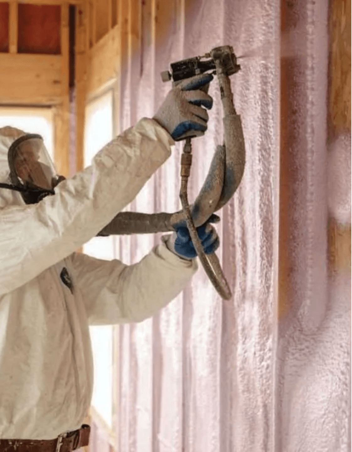 Installer spraying closed-cell spray foam insulation into wall framing in Vancouver